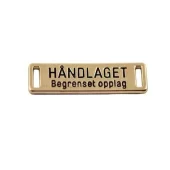 Merke gull metall "Håndlaget" 2,5x0,6cm